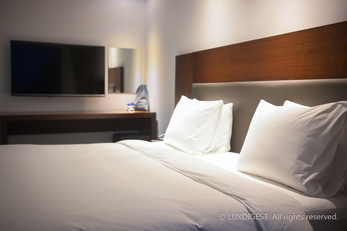 The bed prepared in the hotel room looks soft