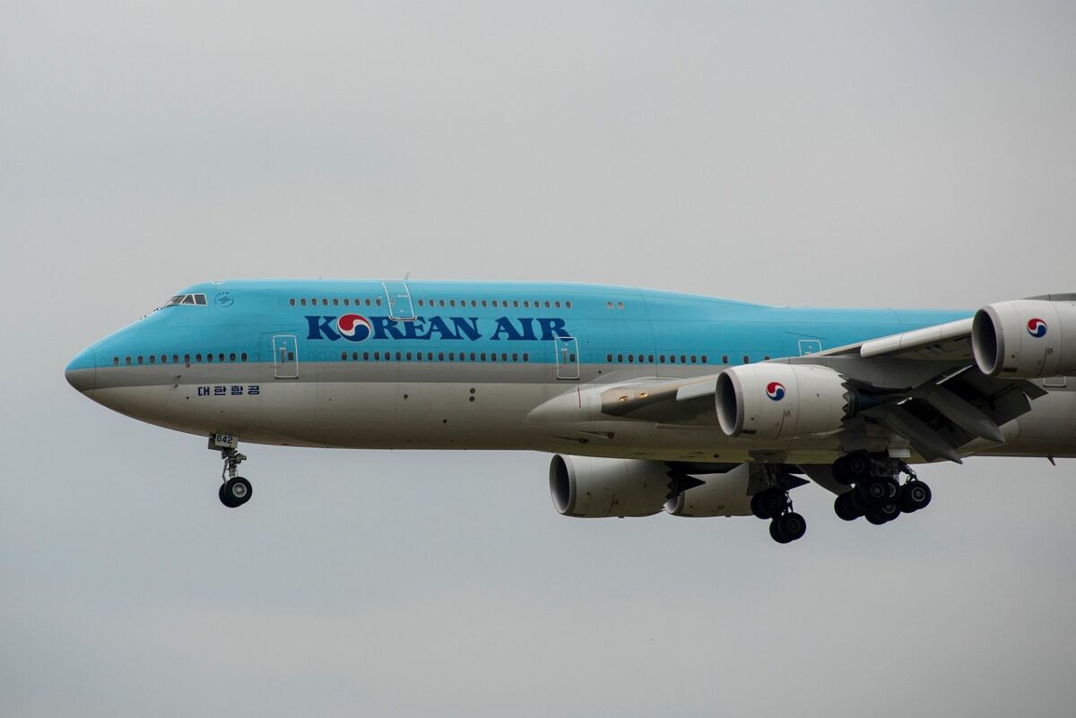 The appearance of a large airline Korean Air plane lowering its altitude for landing