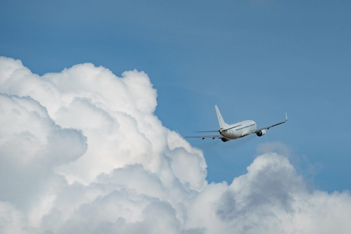 The plane is flying beautifully next to the clouds.