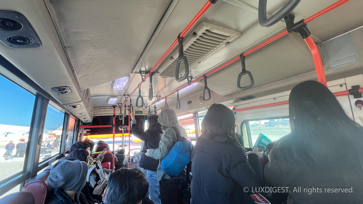 Travelers are boarding a bus to travel by plane