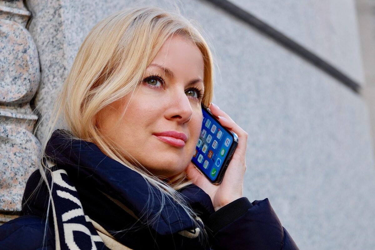 A woman talking on the phone with an iPhone